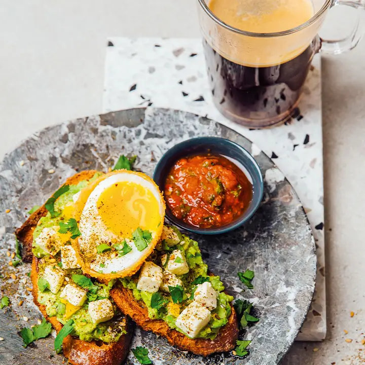 Avocado toast with herbs and citrus garnish