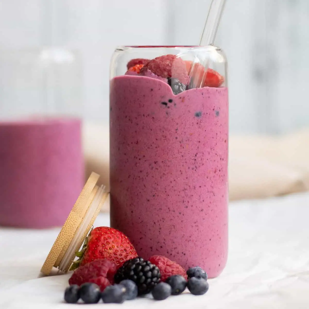 Berry smoothie topped with fresh berries